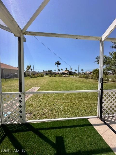 view of yard featuring glass enclosure