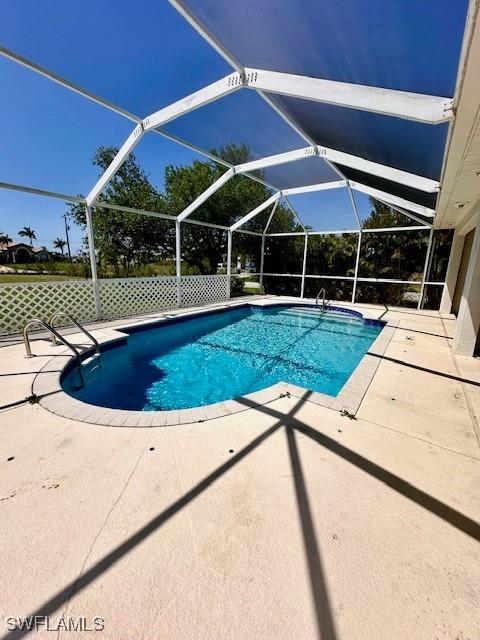 view of pool featuring a lanai and a patio