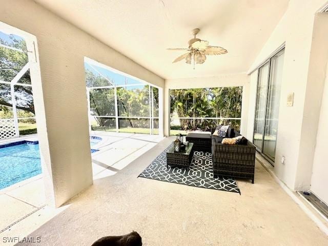 sunroom / solarium featuring ceiling fan