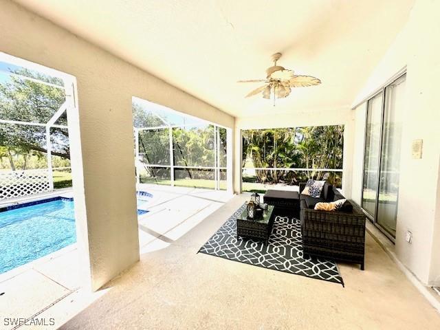 sunroom / solarium featuring ceiling fan and a swimming pool