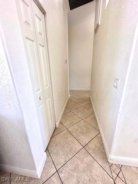 hallway featuring light tile patterned floors