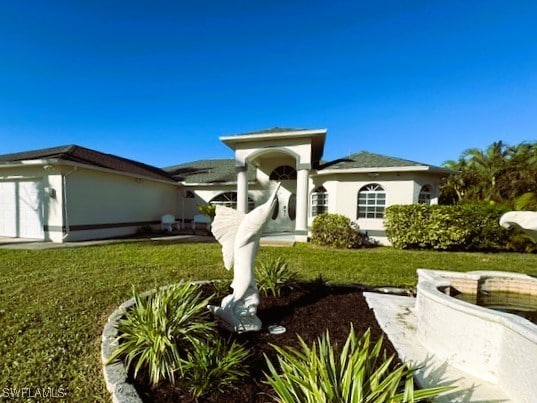 exterior space with a front yard and a garage