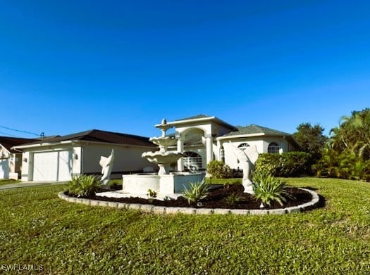 view of front of home featuring a garage and a front lawn