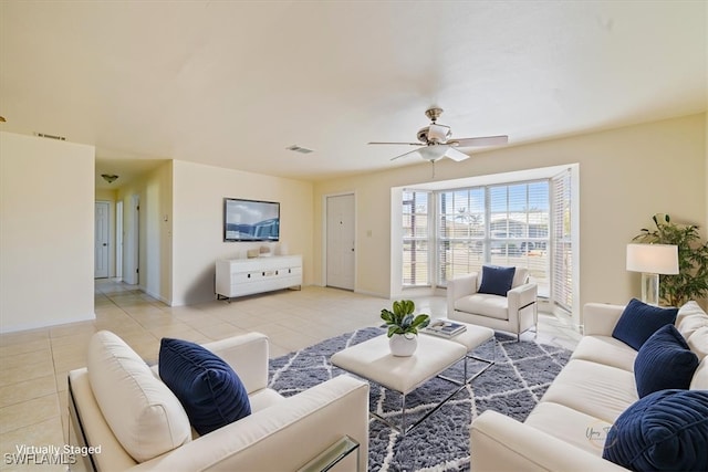 tiled living room with ceiling fan