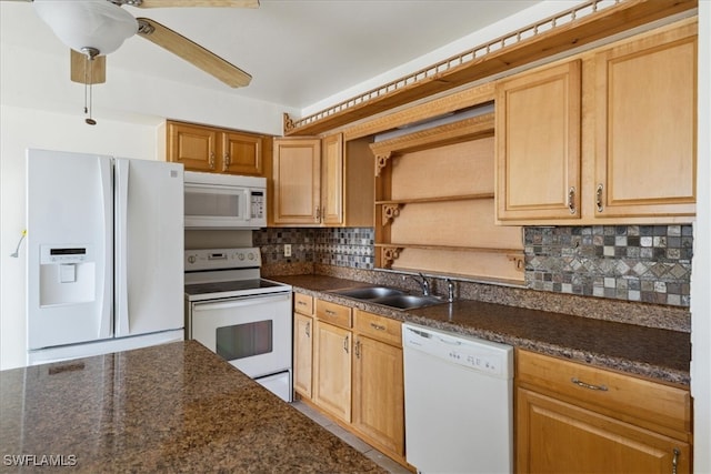 kitchen with tasteful backsplash, white appliances, ceiling fan, sink, and dark stone countertops