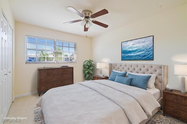 bedroom featuring light carpet, a closet, and ceiling fan