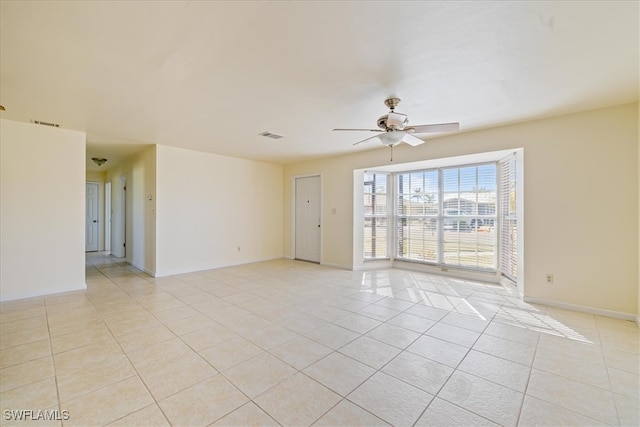 tiled empty room with ceiling fan