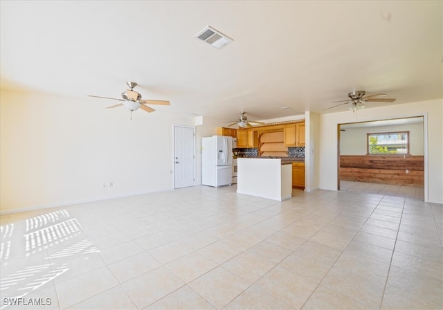 unfurnished living room with light tile patterned floors