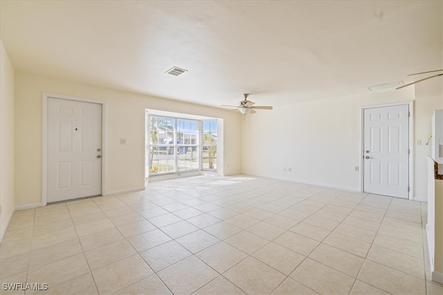 tiled foyer featuring ceiling fan