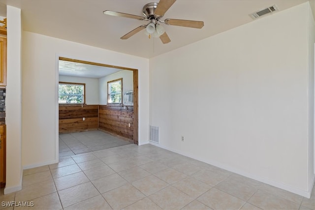 spare room featuring ceiling fan and light tile patterned flooring