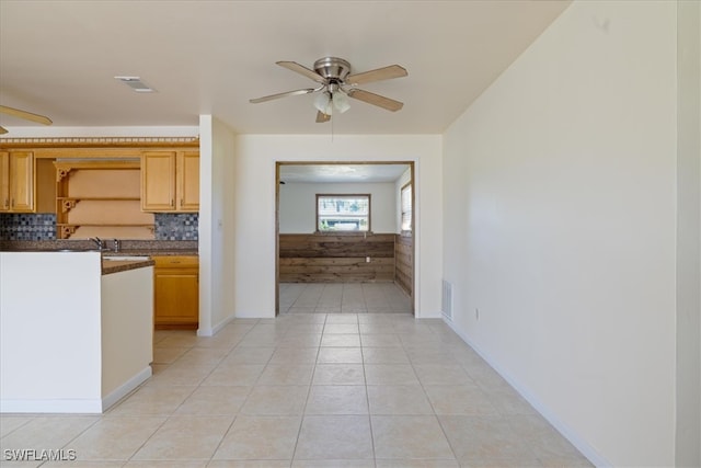 kitchen featuring decorative backsplash, sink, light tile patterned floors, and ceiling fan