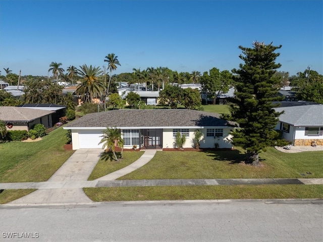 single story home with a garage and a front lawn