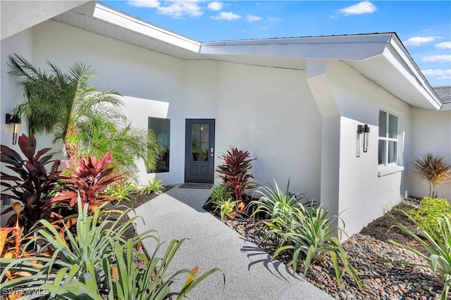 381 Norwood Ct, Fort Myers, FL 33919 - doorway to property with stucco siding