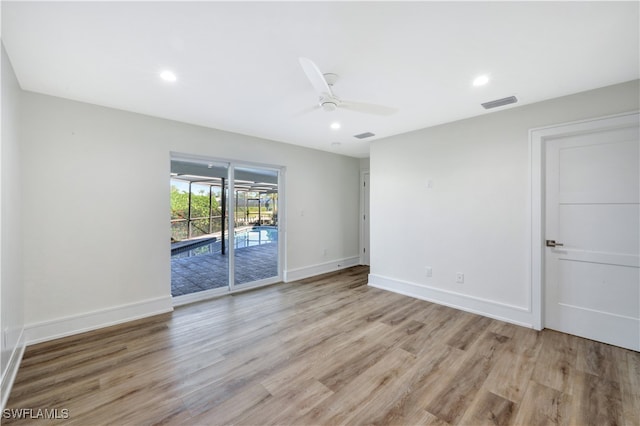 spare room featuring light hardwood / wood-style floors and ceiling fan