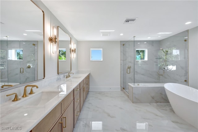 bathroom with vanity, independent shower and bath, and a wealth of natural light