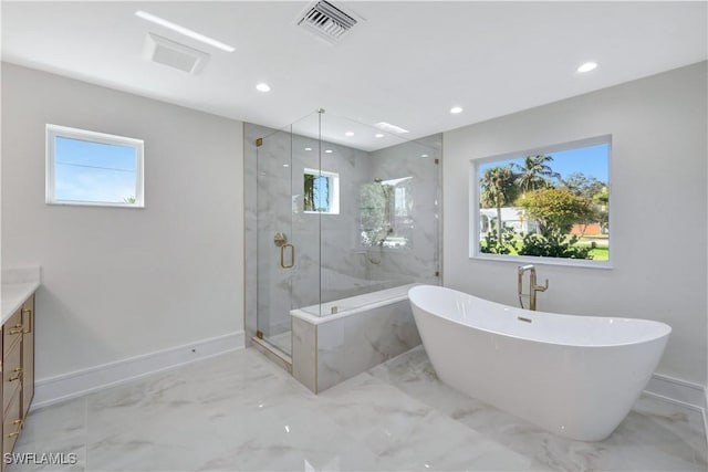 381 Norwood Ct, Fort Myers, FL 33919 - bathroom featuring marble tiled flooring, a freestanding bath, vanity, plenty of natural light, and recessed lighting