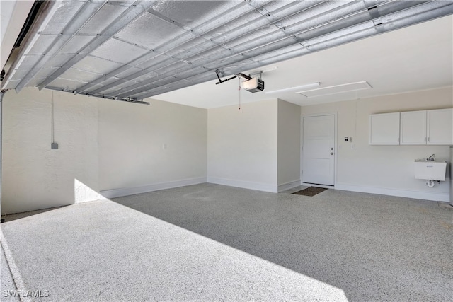 garage with sink and a garage door opener