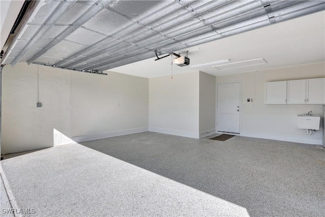 381 Norwood Ct, Fort Myers, FL 33919 - garage featuring a garage door opener, baseboards, and a sink