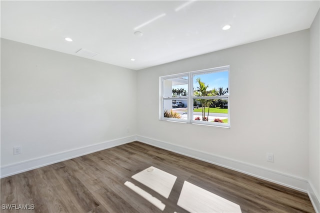 empty room featuring dark hardwood / wood-style flooring