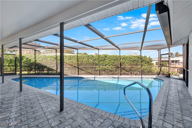 view of swimming pool with a patio area and glass enclosure