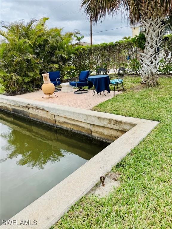 exterior space featuring a patio area and a lawn