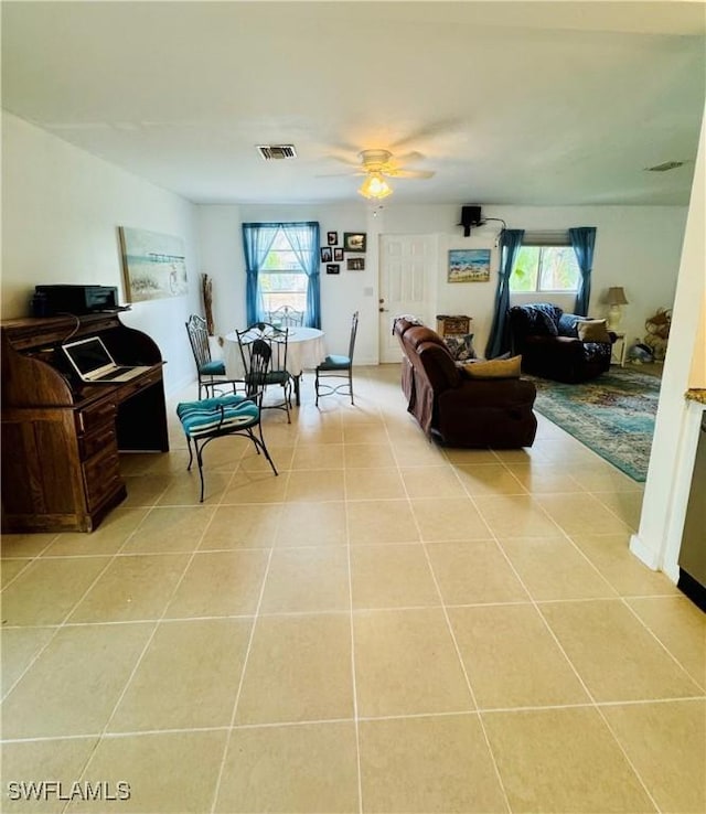 living room featuring ceiling fan and light tile patterned floors