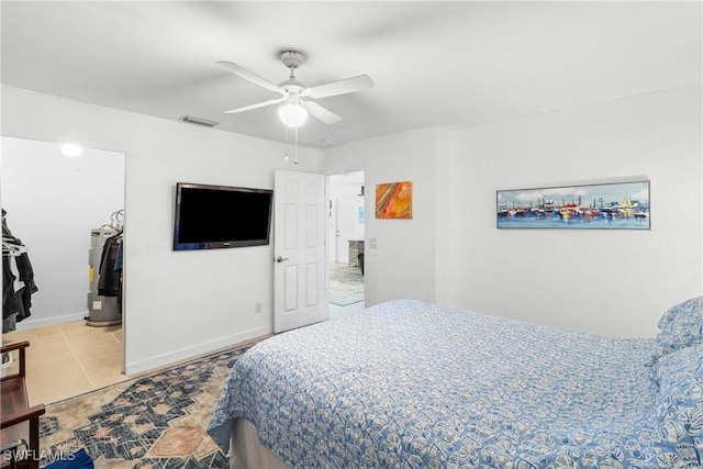 tiled bedroom with ceiling fan and water heater