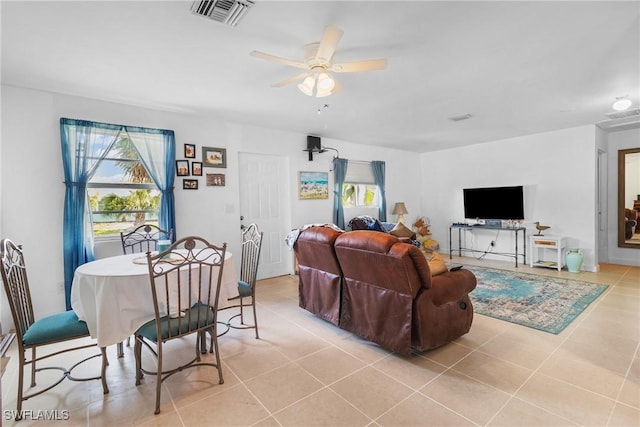 living room with ceiling fan and light tile patterned floors