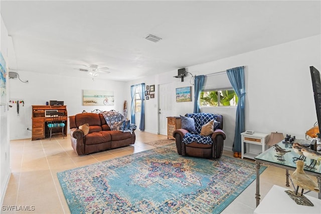 living room featuring light tile patterned floors and ceiling fan