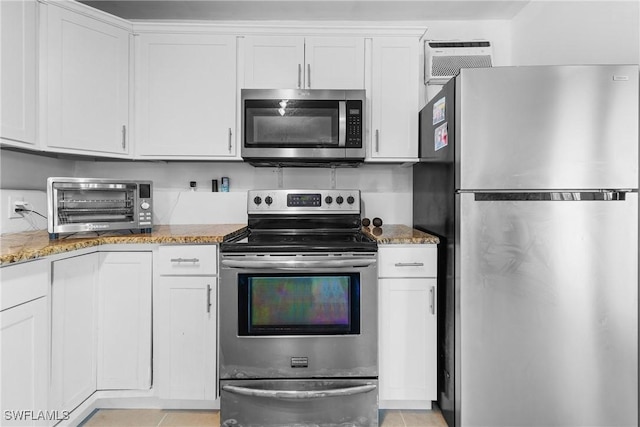 kitchen featuring white cabinetry, stainless steel appliances, and stone counters