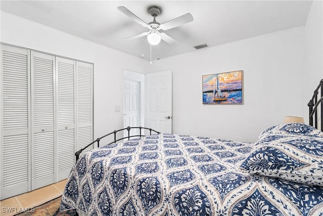 tiled bedroom with a closet and ceiling fan