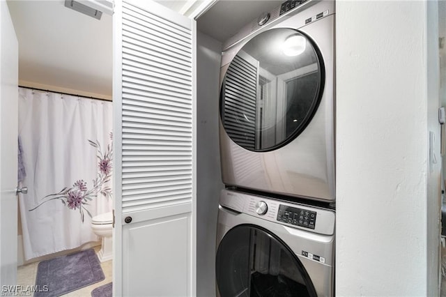 laundry area with stacked washer / drying machine