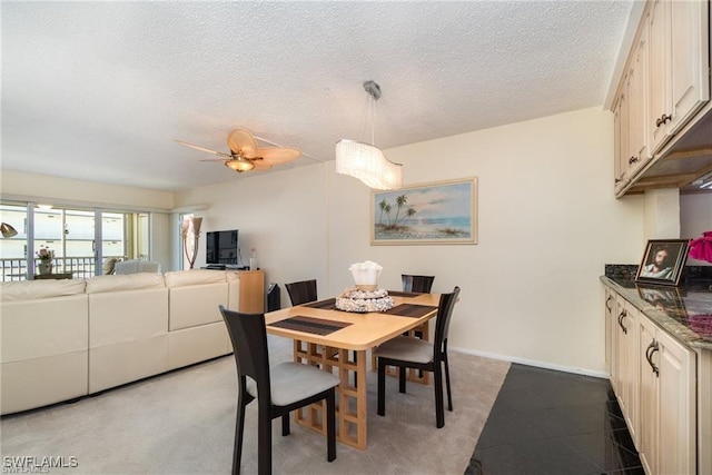 dining room featuring ceiling fan and a textured ceiling