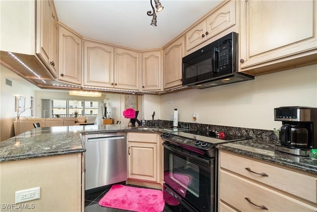 kitchen featuring dark stone countertops, light brown cabinets, and black appliances