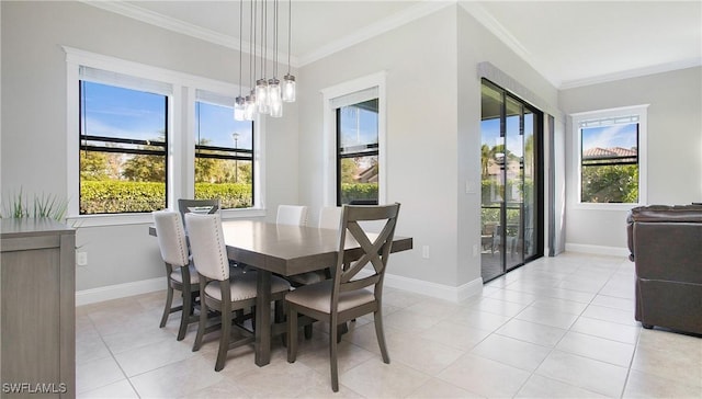 dining area with plenty of natural light, light tile patterned flooring, a chandelier, and ornamental molding