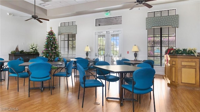 dining space featuring ceiling fan, french doors, light hardwood / wood-style floors, and ornamental molding