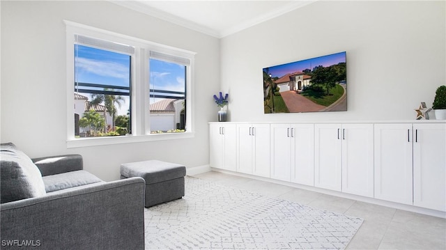 sitting room with crown molding, plenty of natural light, and light tile patterned flooring