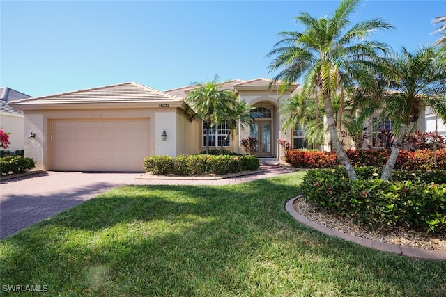 view of front of home with a front yard and a garage