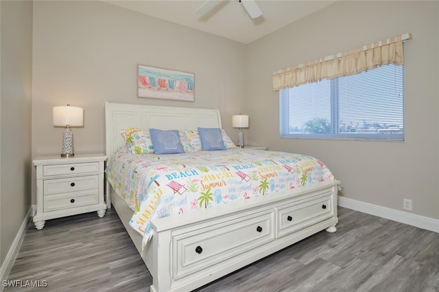 bedroom with dark hardwood / wood-style floors and ceiling fan