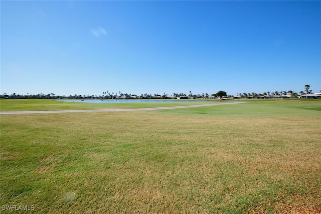 view of property's community with a yard and a water view