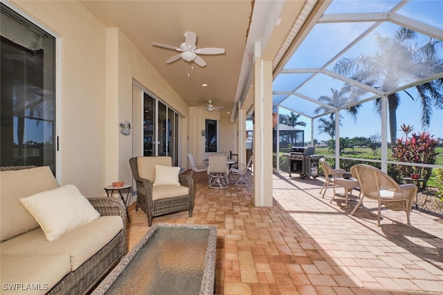 view of patio with ceiling fan, a grill, a lanai, and an outdoor hangout area