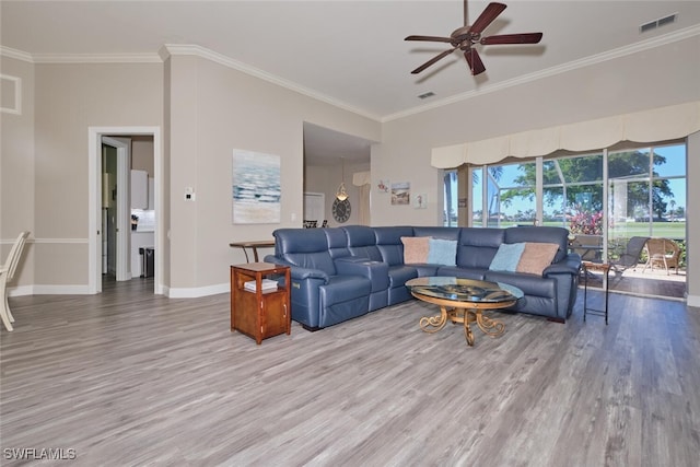 living room featuring ceiling fan, wood-type flooring, and crown molding