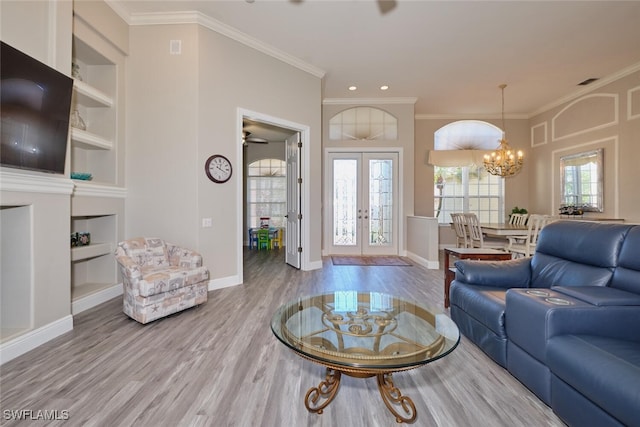 living room featuring french doors, plenty of natural light, ornamental molding, and hardwood / wood-style floors