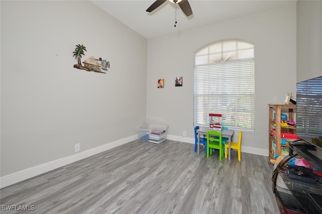 playroom with ceiling fan and light hardwood / wood-style flooring