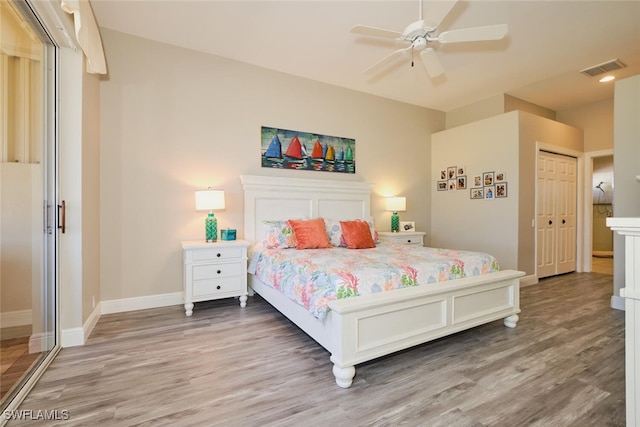 bedroom featuring ceiling fan, wood-type flooring, and a closet