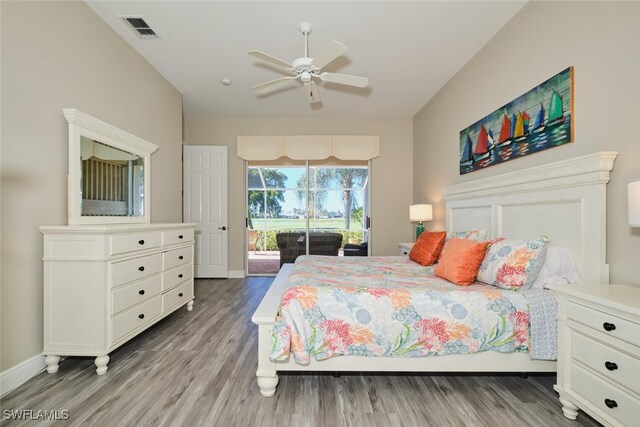 bedroom with access to exterior, hardwood / wood-style flooring, and ceiling fan