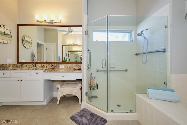 bathroom featuring tile patterned flooring, vanity, and walk in shower