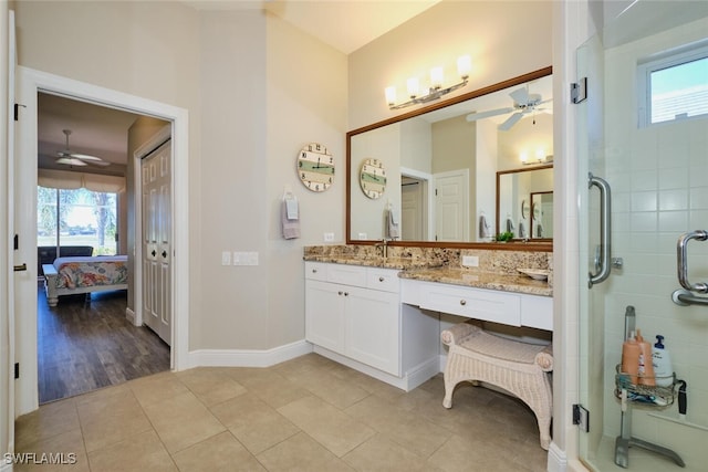 bathroom with hardwood / wood-style flooring, plenty of natural light, an enclosed shower, and vanity