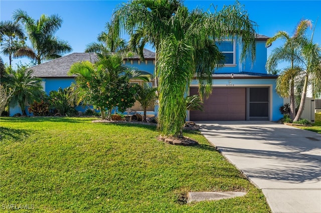 view of front of home featuring a garage and a front yard