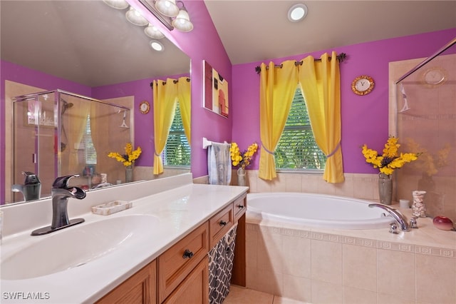 bathroom with tile patterned flooring, lofted ceiling, vanity, and independent shower and bath